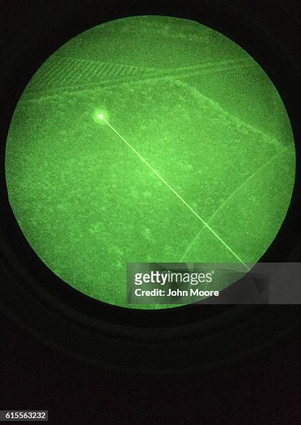 Customs and Border Protection helicopter lasers the location of undocumented immigrants for Border Patrol agents on the ground during a patrol over...