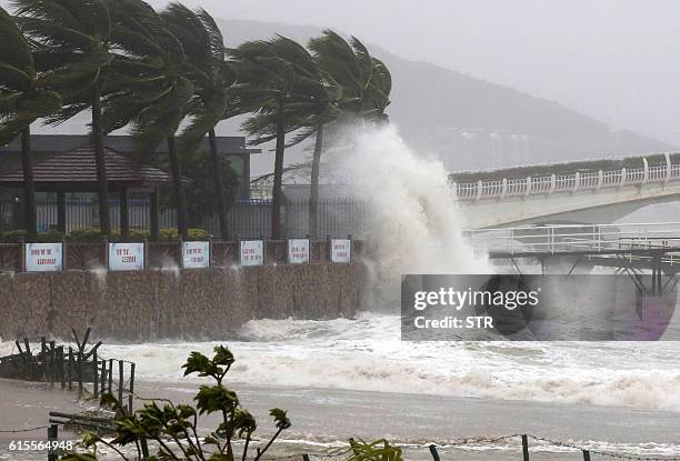 This photo taken on October 18, 2016 shows a huge wave caused by Typhoon Sarika hitting a dike in Sanya, south China's Hainan province. Typhoon...