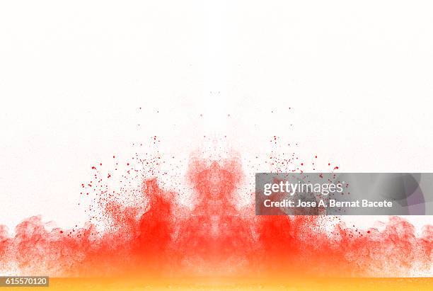 explosion particles of orange and yellow  powder on a white background - poder stock pictures, royalty-free photos & images