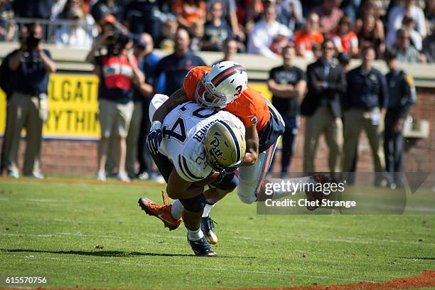 Safety Quin Blanding of the Virginia Cavaliers tackles running back James Conner of the Pittsburgh Panthers during their game at Scott Stadium on...