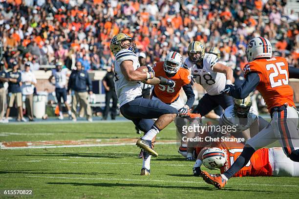 Running back James Conner of the Pittsburgh Panthers spins past Virginia defense during the Panthers' game against the Virginia Cavaliers at Scott...