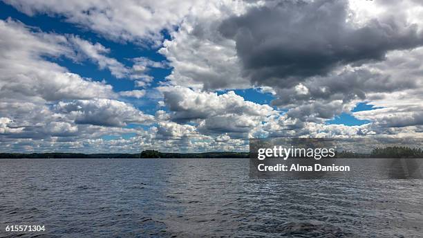 cloudy sky on muskoka lakes - alma danison stock pictures, royalty-free photos & images