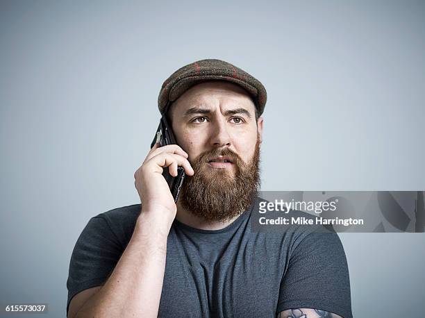 bearded male making phone call - brown hat ストックフォトと画像
