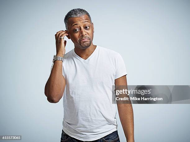 portrait of confused black male - verwirrung stock-fotos und bilder