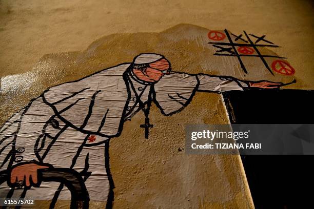 Picture of a new street art mural by Italian artist Maupal showing Pope Francis playing tic-tac-toe and drawing peace signs near the Vatican on...