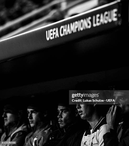 Heung-Min Son of Tottenham and teammates sit on the bench during the UEFA Champions League match between Bayer 04 Leverkusen and Tottenham Hotspur FC...