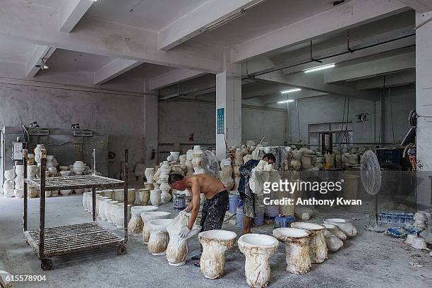 Workers pour liquid latex into molds to make masks of Donald Trump at the Shenzhen Lanbingcai Latex Crafts Factory on October 18, 2016 in Shenzhen,...