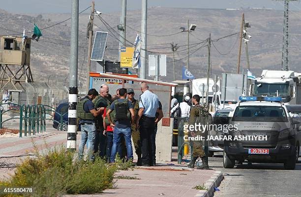 Israeli security forces gather at the site where a Palestinian woman attempted to stab an Israeli border police with a knife before being shot dead,...