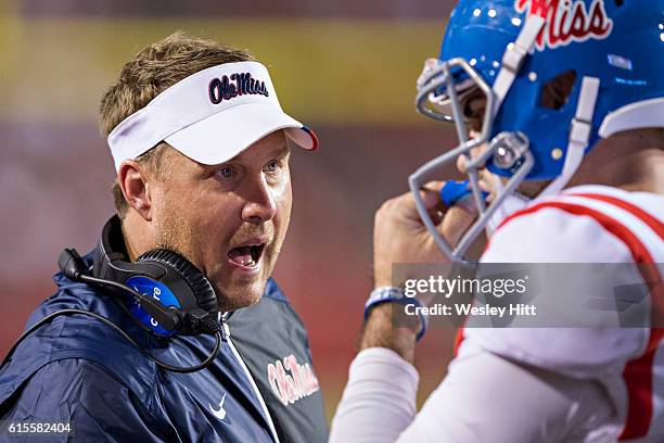 Head Coach Hugh Freeze talks with Chad Kelly of the Mississippi Rebels during a game against the Arkansas Razorbacks at Razorback Stadium on October...