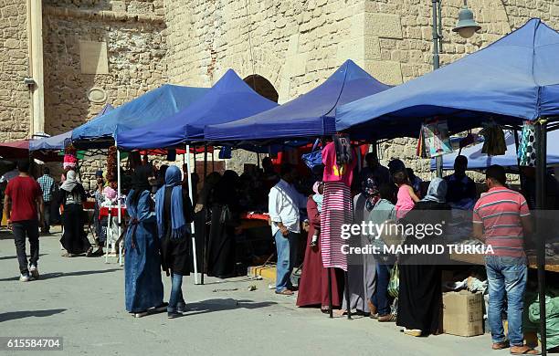 Libyans shop at the Martyrs Square in the capital Tripoli on October 18, 2016. When the 2011 uprising toppled the regime of dictator Moamer Kadhafi,...