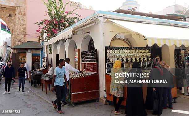 Libyans shop at the Martyrs Square in the capital Tripoli on October 18, 2016. When the 2011 uprising toppled the regime of dictator Moamer Kadhafi,...