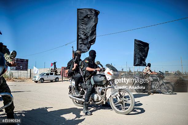 Members of Al-Quds Brigades, armed wing of Palestinian Islamic Jihad Movement pass along the streets during a parade, staged to mark 29th foundation...