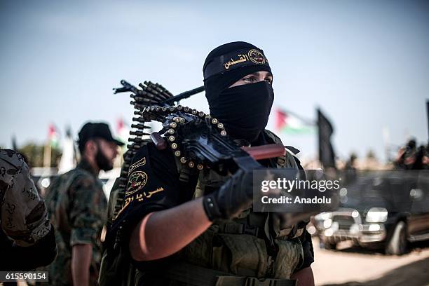 Members of Al-Quds Brigades, armed wing of Palestinian Islamic Jihad Movement march during a parade, staged to mark 29th foundation anniversary of...