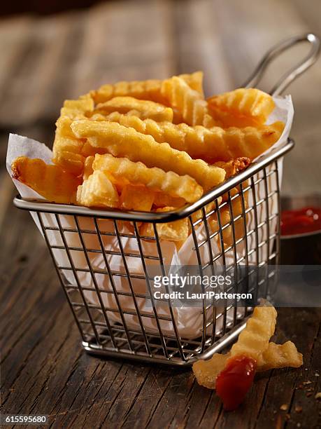 basket of crinkle cut french fries - scalloped stock pictures, royalty-free photos & images