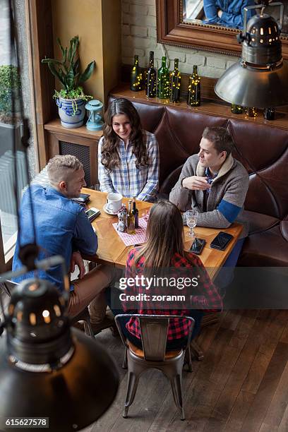 friends in cafe - double date stock pictures, royalty-free photos & images