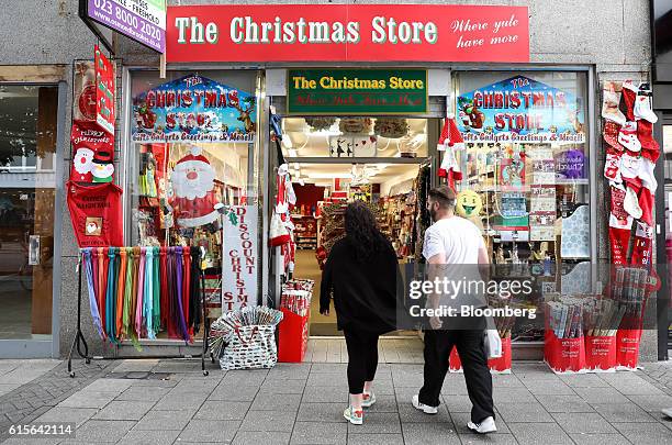 Shoppers enter a pop-up Christmas products store in Southampton, U.K., on Wednesday, Oct. 19, 2016. U.K. Inflation accelerated to the fastest in...