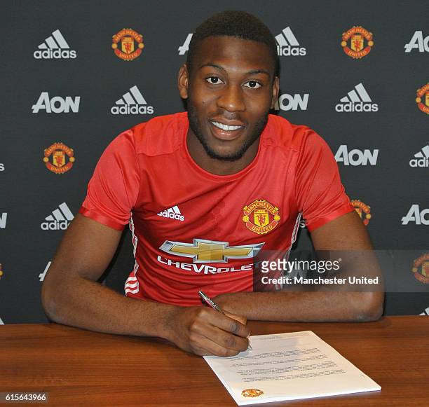 Timothy Fosu-Mensah of Manchester United signs a new contract at Aon Training Complex on October 19, 2016 in Manchester, England.