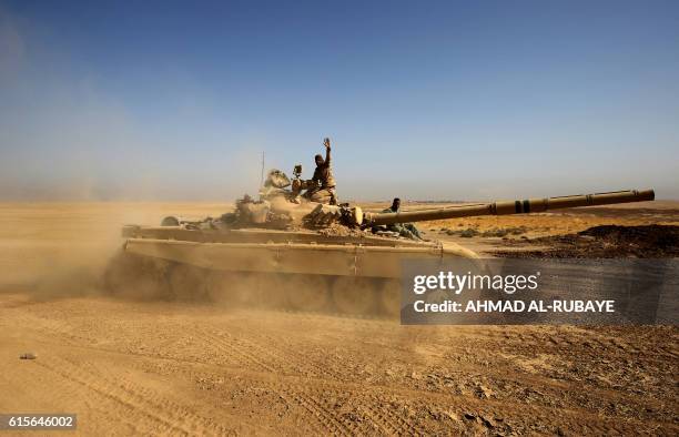 An Iraqi forces T-72 tank takes position near the village of Tall al-Tibah, some 30 kilometres south of Mosul, on October 19 during an operation...