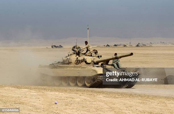 An Iraqi forces T-72 tank takes position near the village of Tall al-Tibah, some 30 kilometres south of Mosul, on October 19 during an operation...