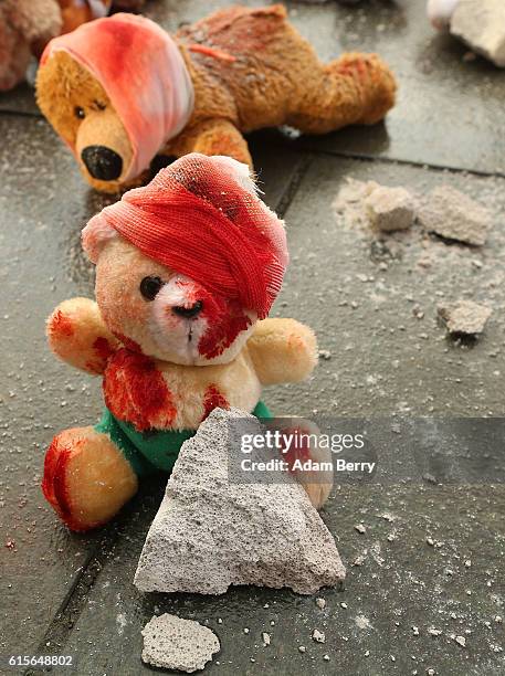Bloodied teddy bears are seen during a demonstration against Russian military operations in Syria during a visit by Russian President Vladimir Putin...