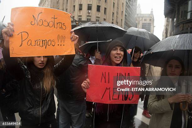 Women stop work and other activities for an hour to join a "women's strike" organized after the brutal killing of a 16-year-old girl, in Buenos...