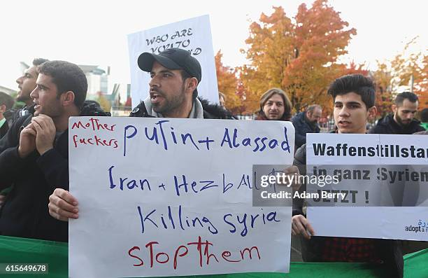 Activists demonstrate at a protest against Russian military operations in Syria during a visit by Russian President Vladimir Putin to the German...