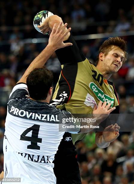 Domagoj Duvnjak of Kiel challenges for the ball with Fabian Boehm of Hannover-Burgdorf during the DKB HBL Bundesliga match between THW Kiel and TSV...