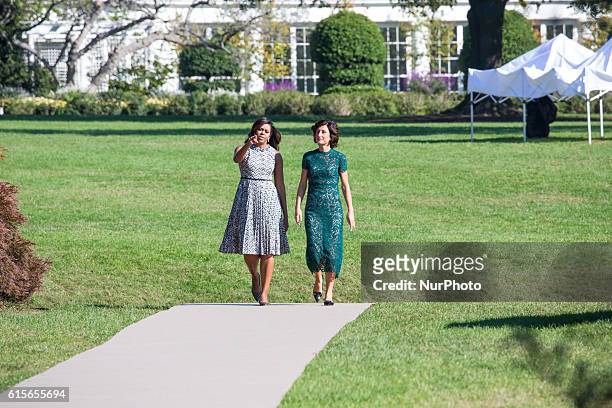 , First Lady Michelle Obama, and Mrs. Agnese Landini, make their way out to the White House Kitchen Garden on the South Lawn in Washington, DC, USA,...