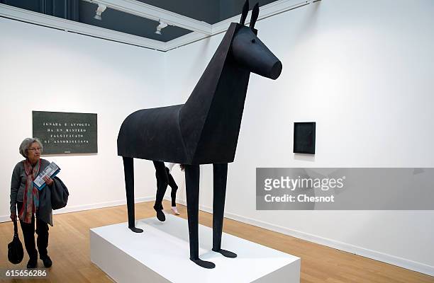 Visitor looks at an artwork entitled 'Horse' by artists Joao Maria Gusmao and Pedro Paiva at the Grand Palais as part of the FIAC international...
