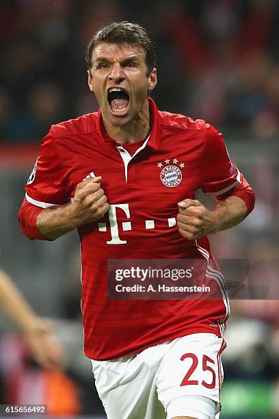 Thomas Mueller of Muenchen celebrates scoring the opening goal during the UEFA Champions League group D match between FC Bayern Muenchen and PSV...
