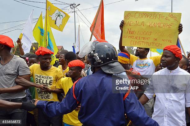 Hundreds of people hold placards and protest against the government of Democratic Republic of Congo's President Joseph Kabila on October 19, 2016 in...