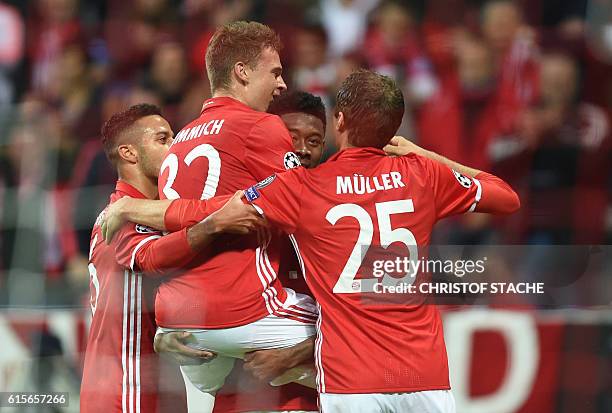 Bayern Munich's midfielder Joshua Kimmich celebrates scoring with Bayern Munich's Spanish midfielder Thiago Alcantara, Bayern Munich's Austrian...