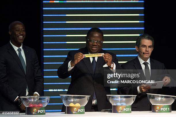 Gabonese Prime Minister Franc-Emmanuel Issoze Ngonde shows a piece of paper bearing the name of Guinea Bissau as next to Confederation of African...