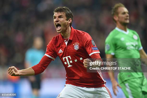 Bayern Munich's striker Thomas Mueller celebrates after the first goal during the UEFA Champions League group D football match FC Bayern Munich vs...