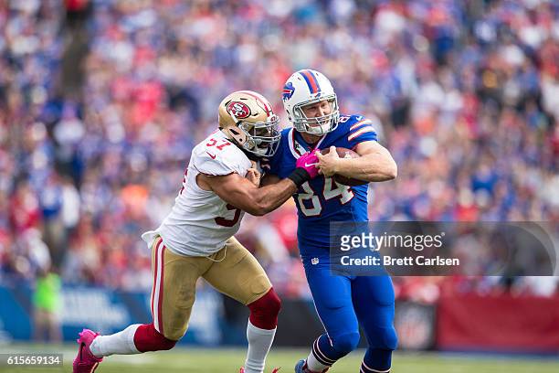 Nick O'Leary of the Buffalo Bills fights off a tackle by Michael Wilhoite of the San Francisco 49ers during the first half on October 16, 2016 at New...
