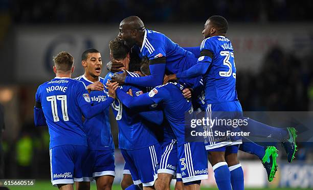 Cardiff player Peter Whittingham is submerged by team mates including Sol Bamba after scoring the opening goal from a free kick during the Sky Bet...