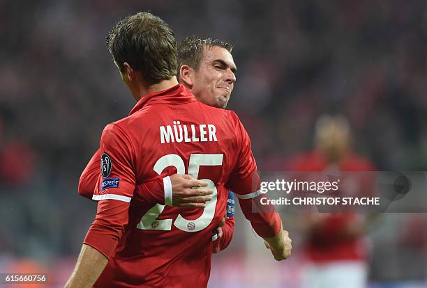 Bayern Munich's striker Thomas Mueller and Bayern Munich's defender Philipp Lahm celebrate after the first goal during the UEFA Champions League...