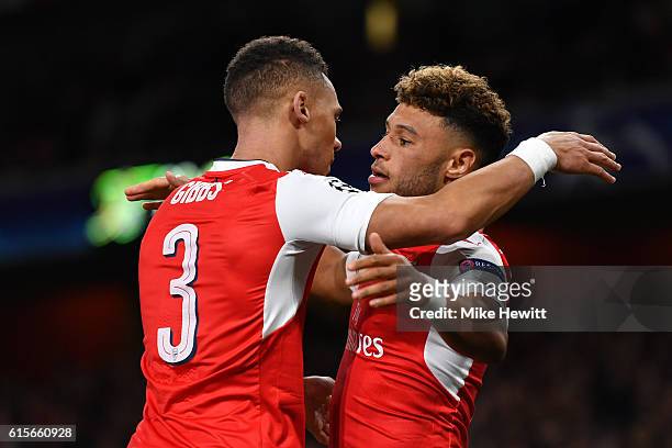Alex Oxlade-Chamberlain of Arsenal celebrates with team mate Kieran Gibbs after scoring his team's third goal of the game during the UEFA Champions...