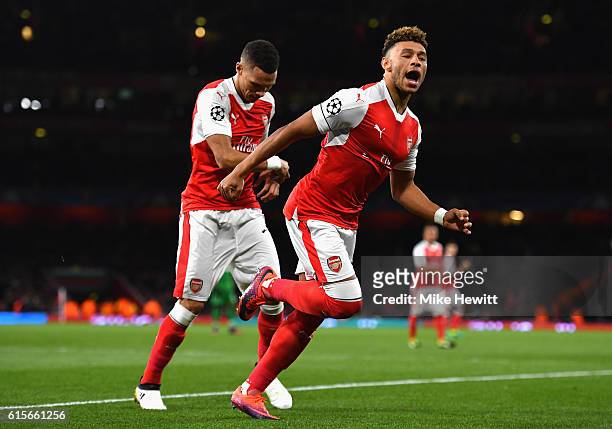Alex Oxlade-Chamberlain of Arsenal celebrates after scoring his team's third goal of the game during the UEFA Champions League group A match between...