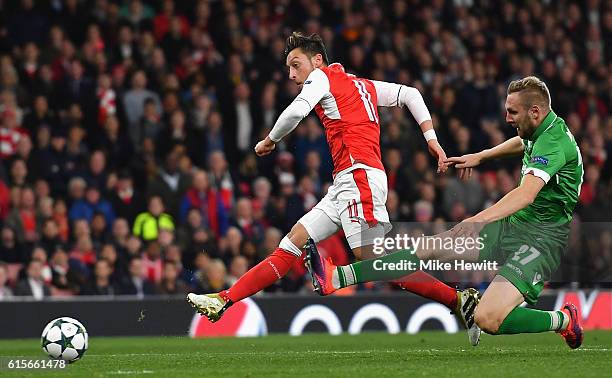 Mesut Ozil of Arsenal scores his team's fourth goal of the game during the UEFA Champions League group A match between Arsenal FC and PFC Ludogorets...