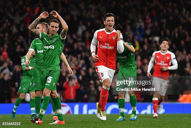 Mesut Ozil of Arsenal celebrates after scoring his thirs and his team's sixth goal of the game during the UEFA Champions League group A match between...