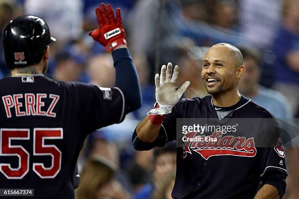 Coco Crisp of the Cleveland Indians celebrates with Roberto Perez after hitting a solo home run in the fourth inning against Marco Estrada of the...