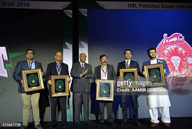 Pakistan Super League chairman Najam Sethi poses with team owners during second edition of PSL draft in Dubai on October 19, 2016. Pakistan's...