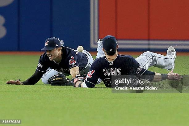 Lonnie Chisenhall and Jason Kipnis of the Cleveland Indians miss a ball hit by Russell Martin of the Toronto Blue Jays in the fifth inning during...