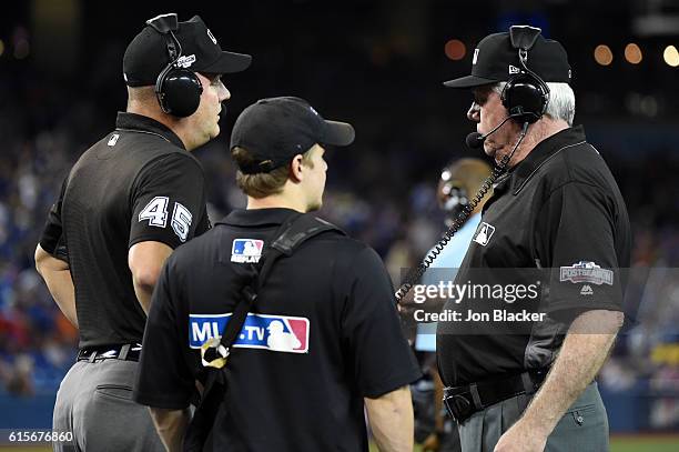 Umpires Jeff Nelson and Brian Gorman review a double play during Game 5 of the ALCS between the Cleveland Indians and the Toronto Blue Jays at the...