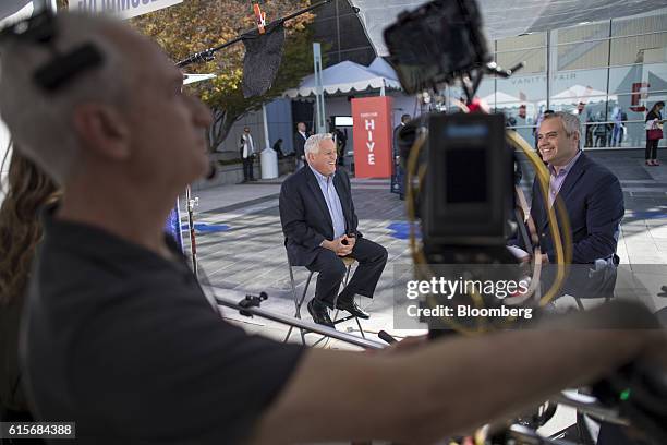 Walter Isaacson, president and chief executive officer of the Aspen Institute, center, laughs during a Bloomberg Television interview at the Vanity...