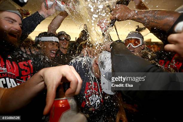 Francisco Lindor of the Cleveland Indians celebrates with his teammates by spraying manager Terry Francona in the locker room after defeating the...