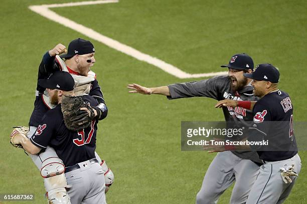 Cody Allen and Roberto Perez of the Cleveland Indians celebrate with their teammates Andrew Miller and Coco Crisp after defeating the Toronto Blue...