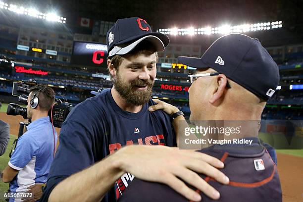 Andrew Miller and Manager Terry Francona of the Cleveland Indians celebrate after defeating the Toronto Blue Jays with a score of 3 to 0 in game five...