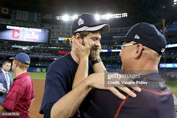 Andrew Miller and Manager Terry Francona of the Cleveland Indians celebrate after defeating the Toronto Blue Jays with a score of 3 to 0 in game five...